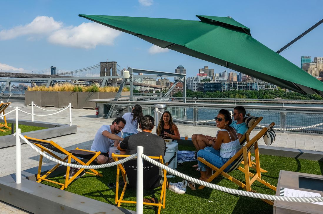 Small artificial grass squares on the rooftop of Pier 17's mall